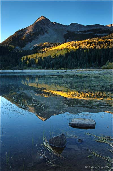 East Beckwith Mountain is reflected in Lost Lake Slough at sunrise as autumn aspen add streaks of gold. &nbsp;